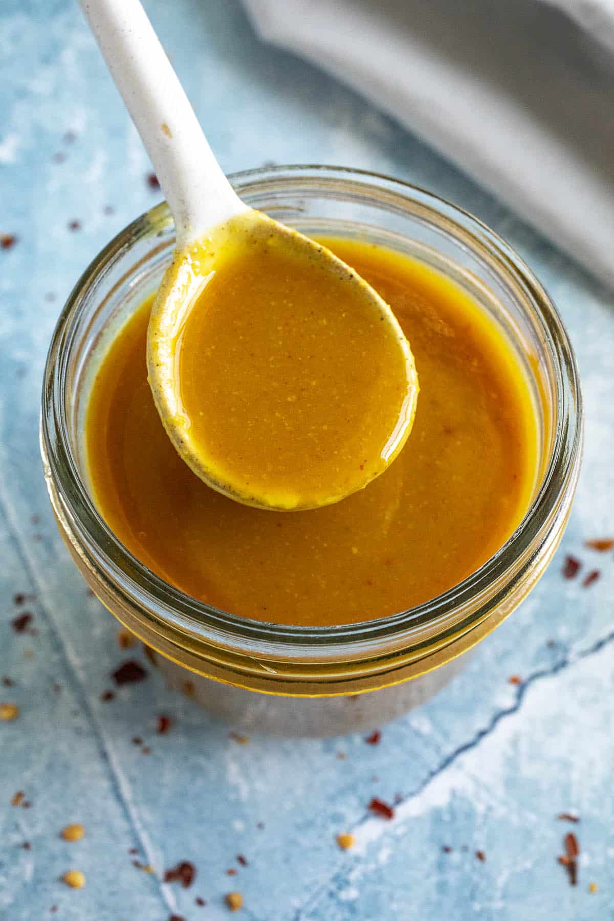 Mike serving tangy Carolina Gold BBQ Sauce with a spoon