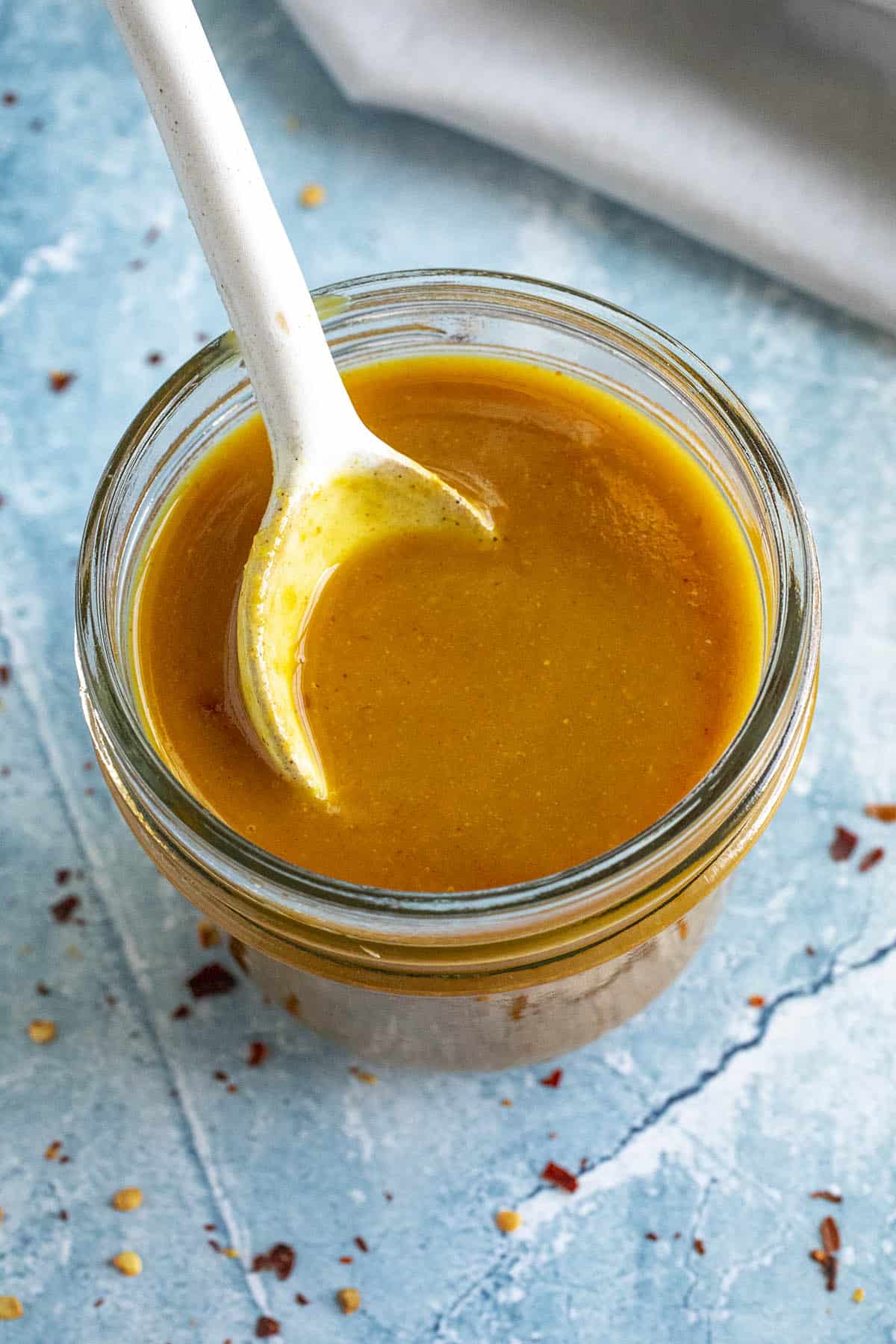 Carolina Gold BBQ Sauce in a jar with a spoon