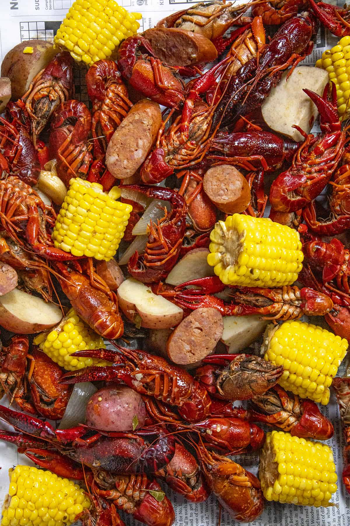 A hearty Crawfish Boil piled over newspaper on a table