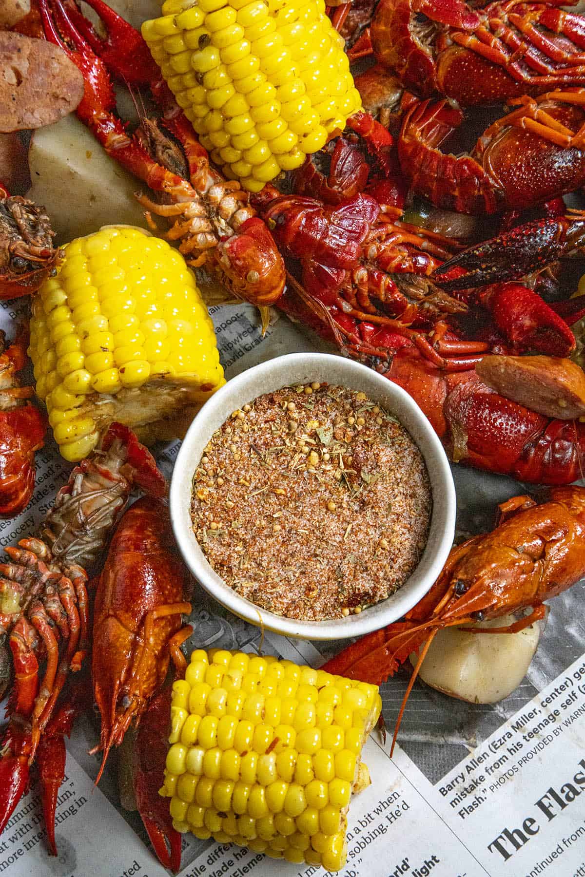 Seafood Boil Seasoning in a bowl, surrounded by crawfish