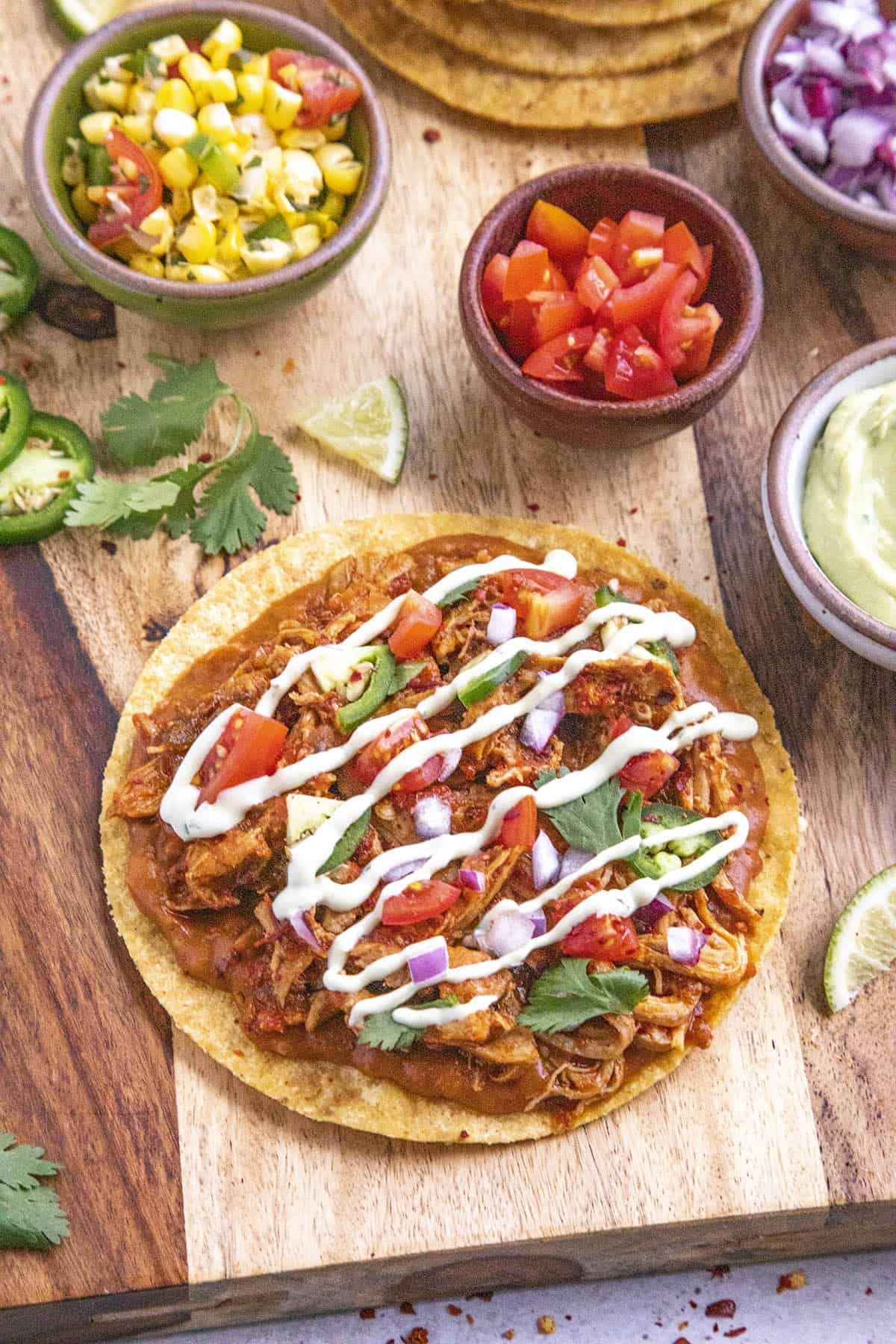 Chicken Tinga Tostadas with avocado crema and lots of toppings