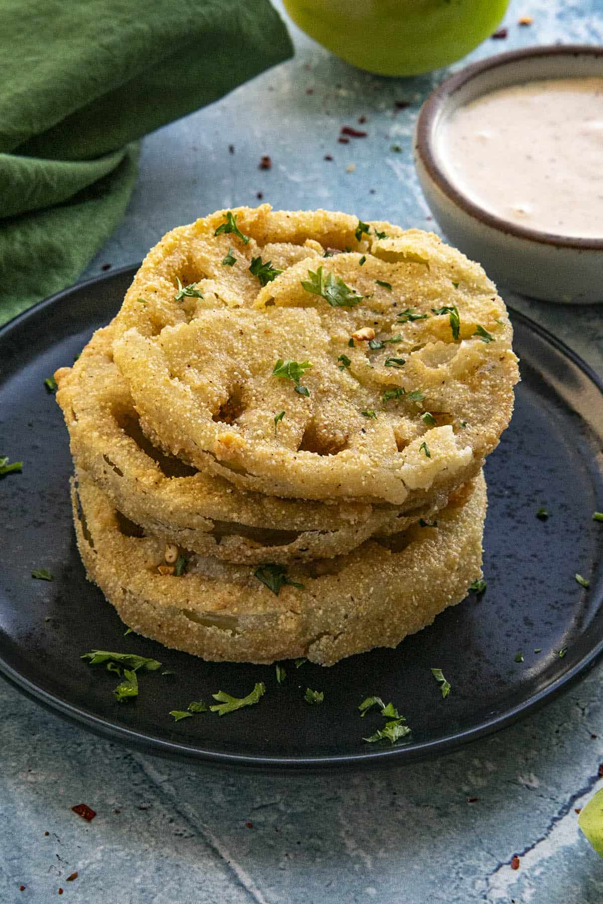 A plate of 3 Fried Green Tomatoes ready to serve, with remoulade