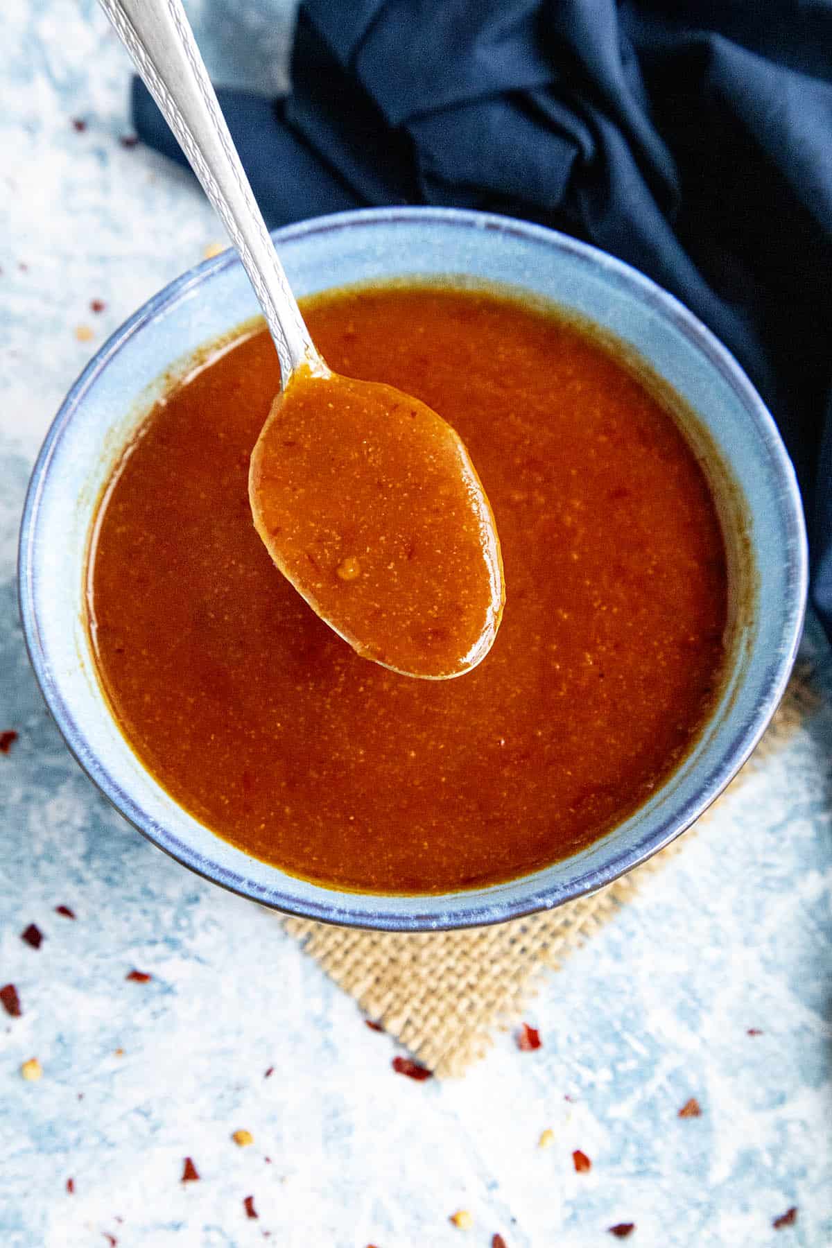 Honey Sriracha Sauce in a bowl with a spoon