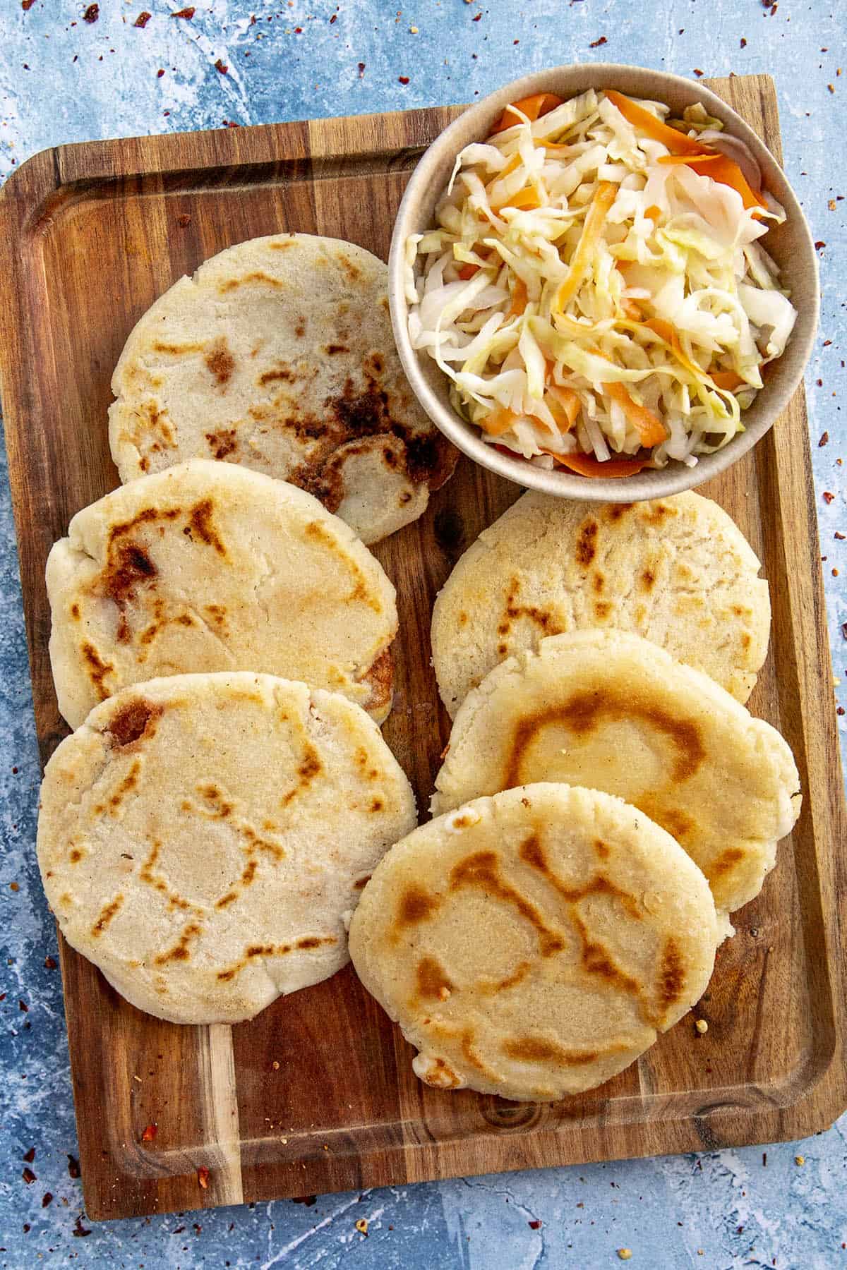 Salvadoran pupusas on a platter with curtido, or cabbage relish