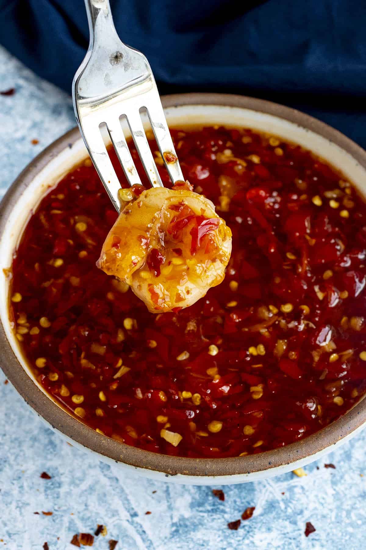 Dipping shrimp into a bowl of Thai Sweet Chili Sauce