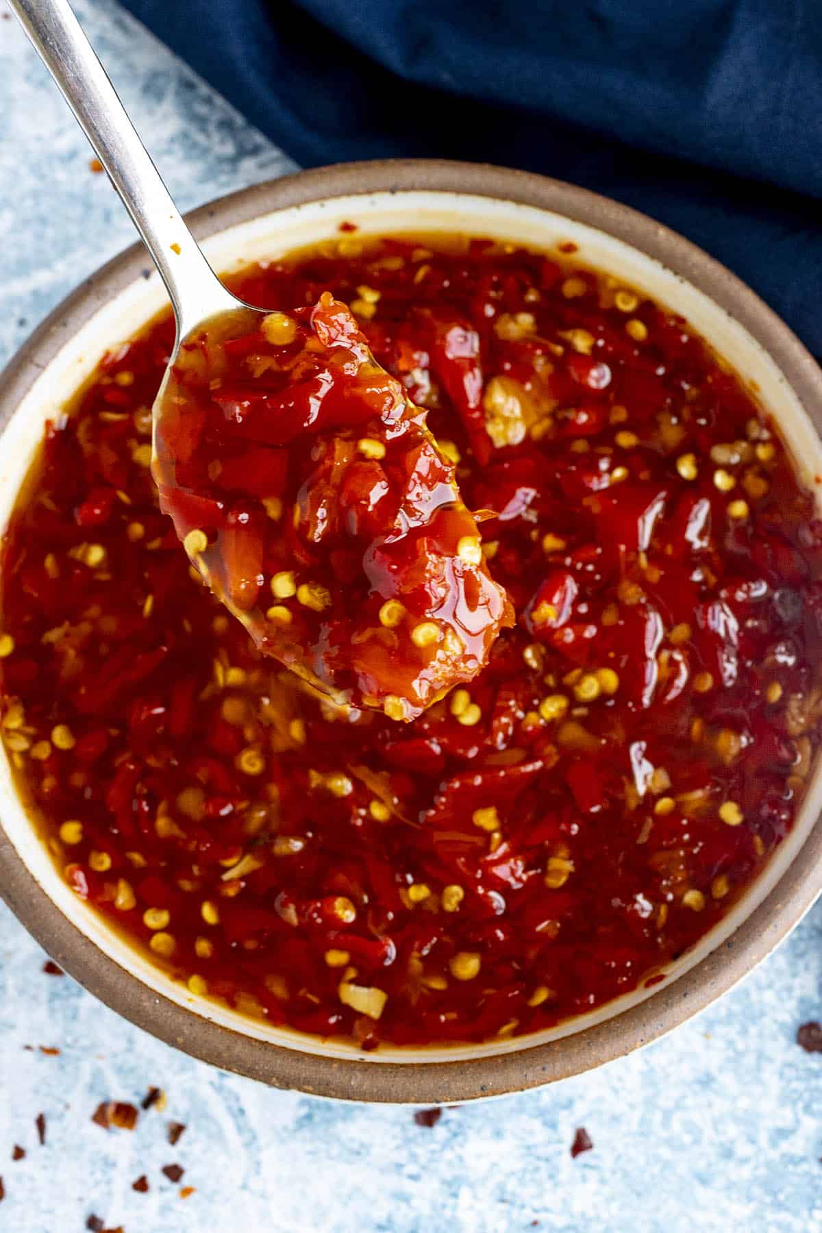 Dipping a spoon into a bowl of Thai Sweet Chili Sauce
