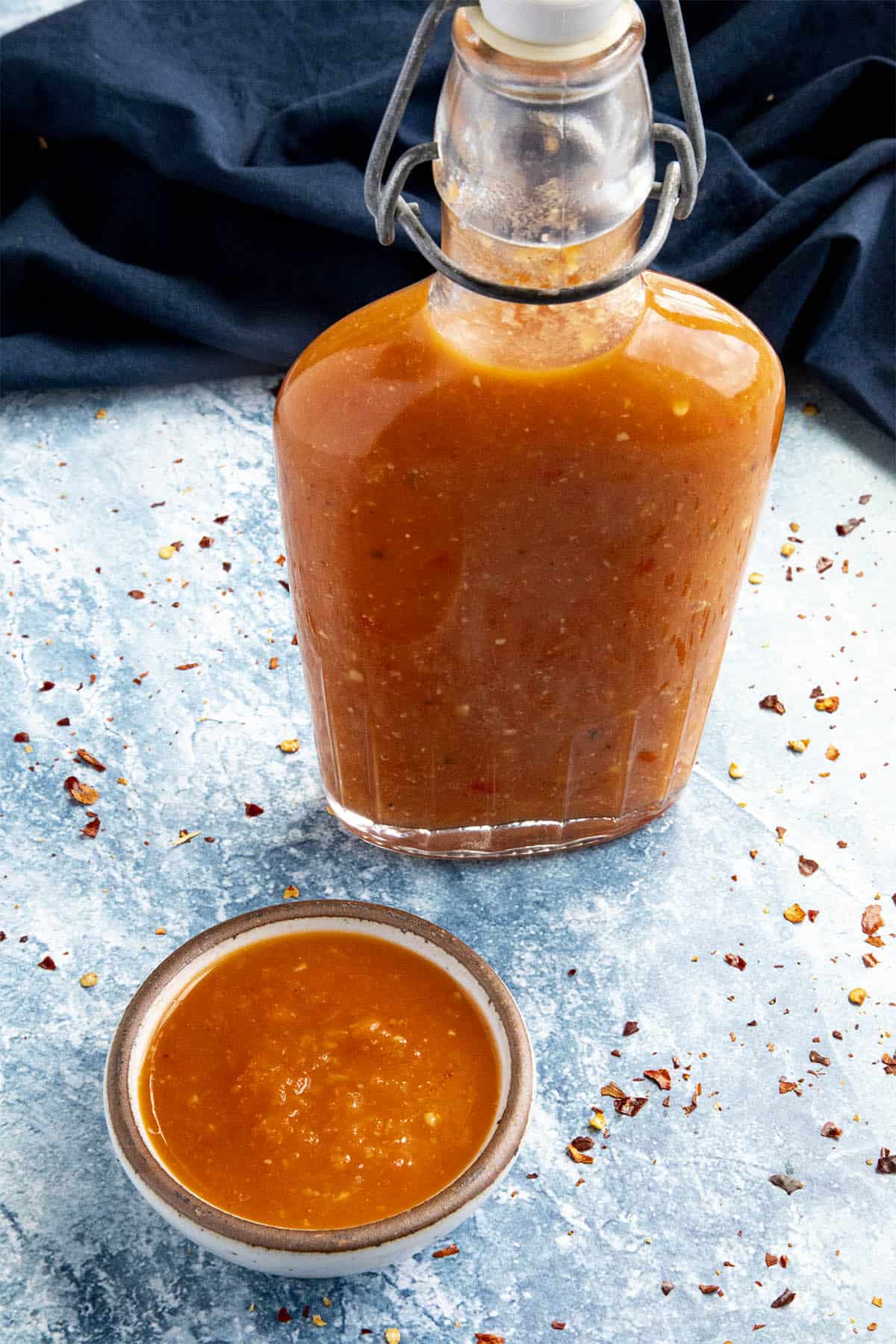 A bowl and a bottle of Ti-Malice Hot Sauce (Hatian Hot Sauce)