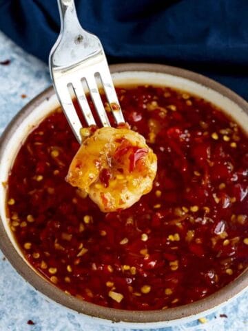 Dipping shrimp into a bowl of Thai Sweet Chili Sauce