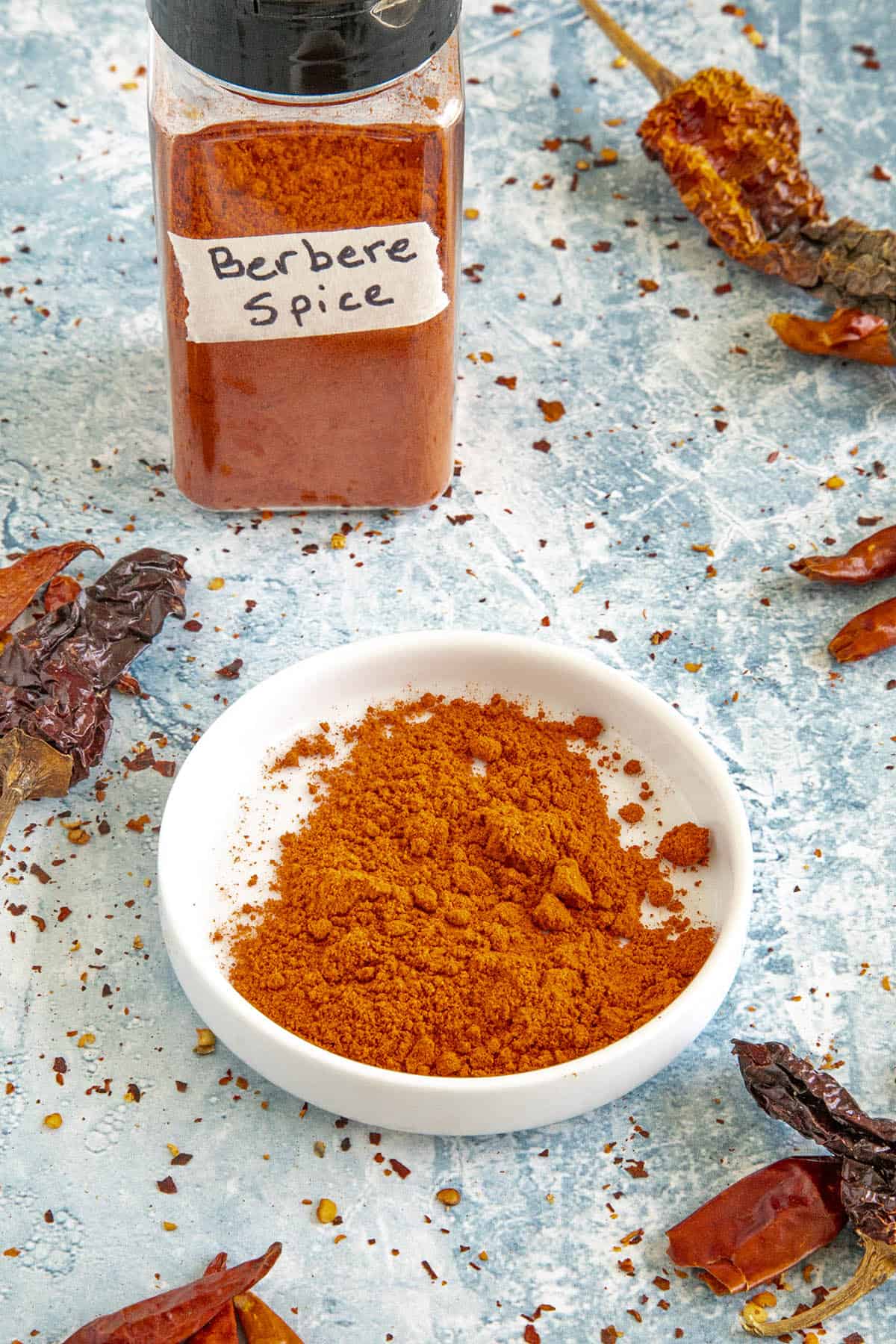 Homemade berbere seasoning in a bowl and in a container