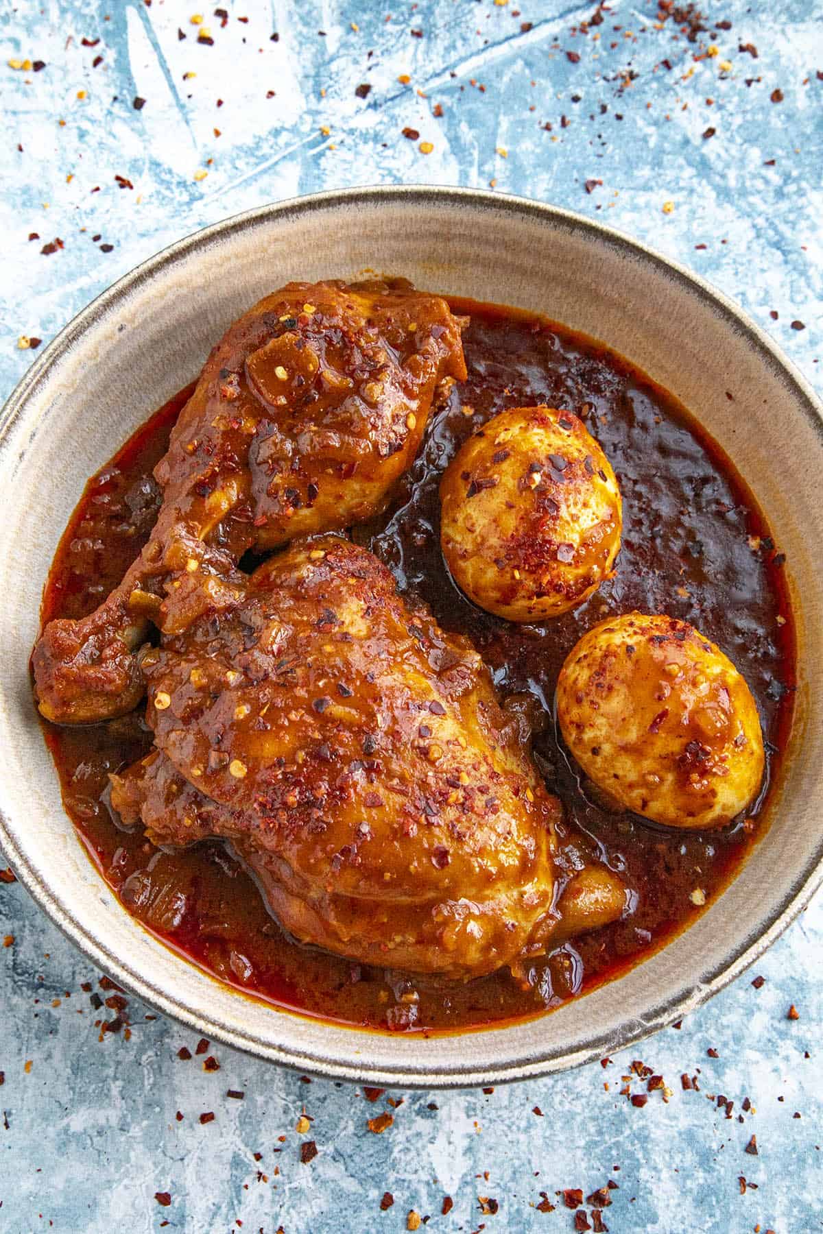 Doro Wat (Ethiopian Chicken Stew) in a bowl with lots of berbere sauce.