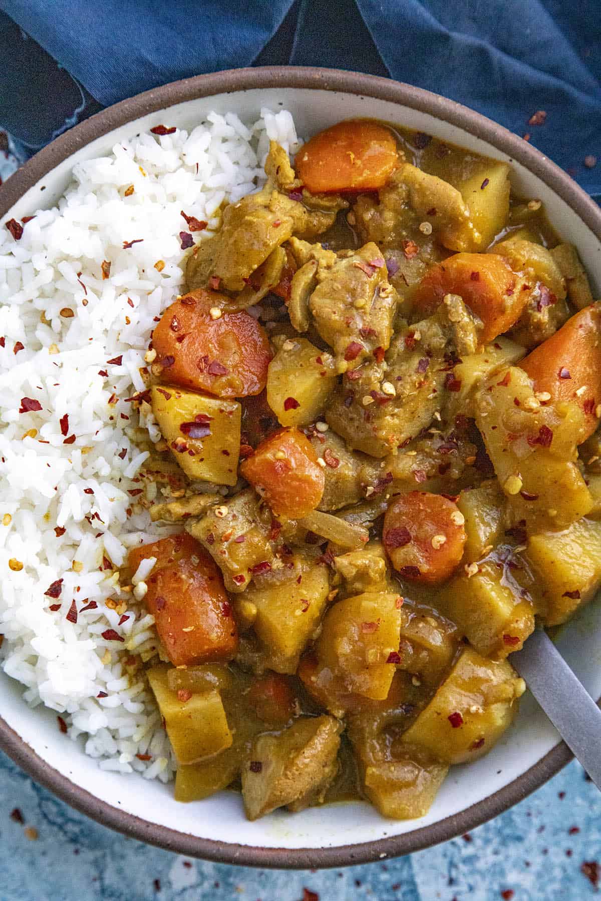 Japanese Curry in a bowl, garnished with chili flakes