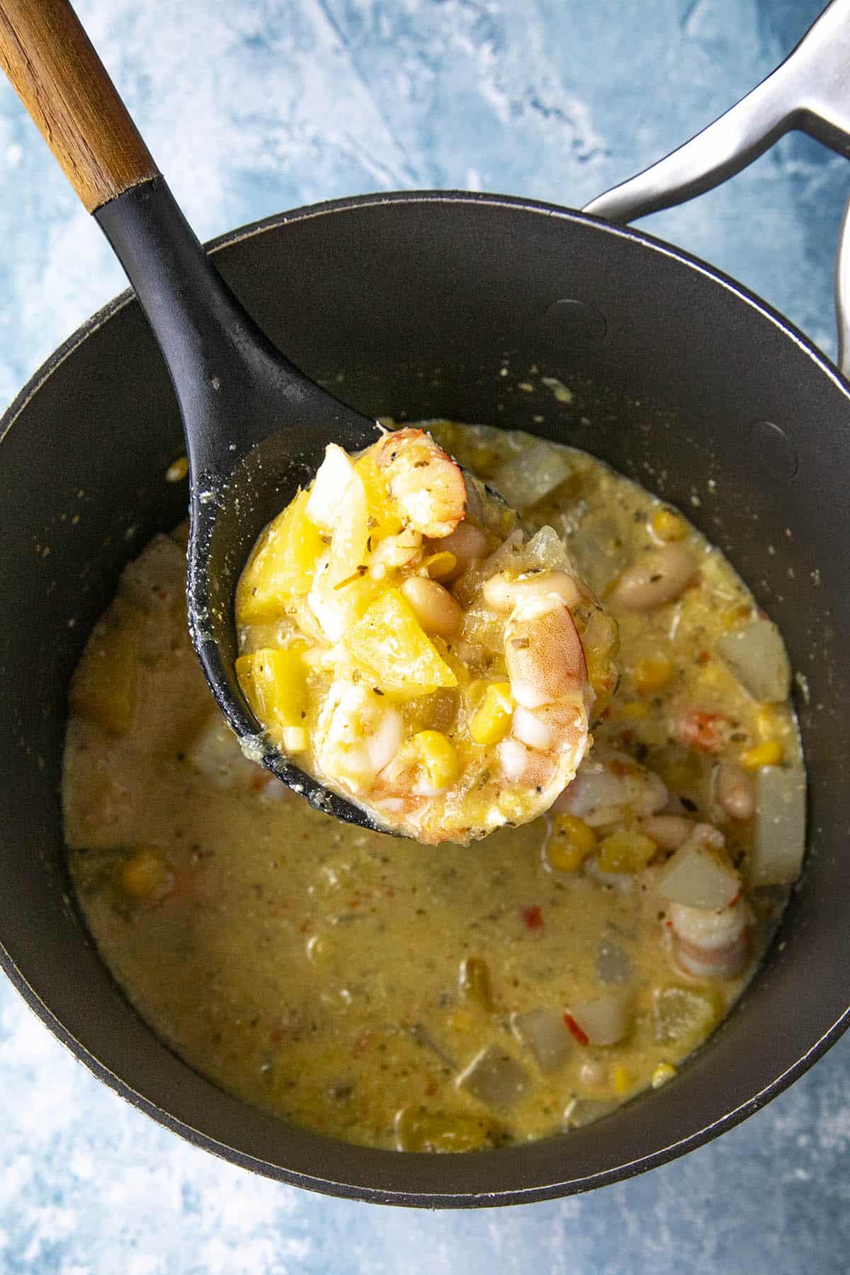 Mike taking a scoop of Peruvian Squash Stew from the pot