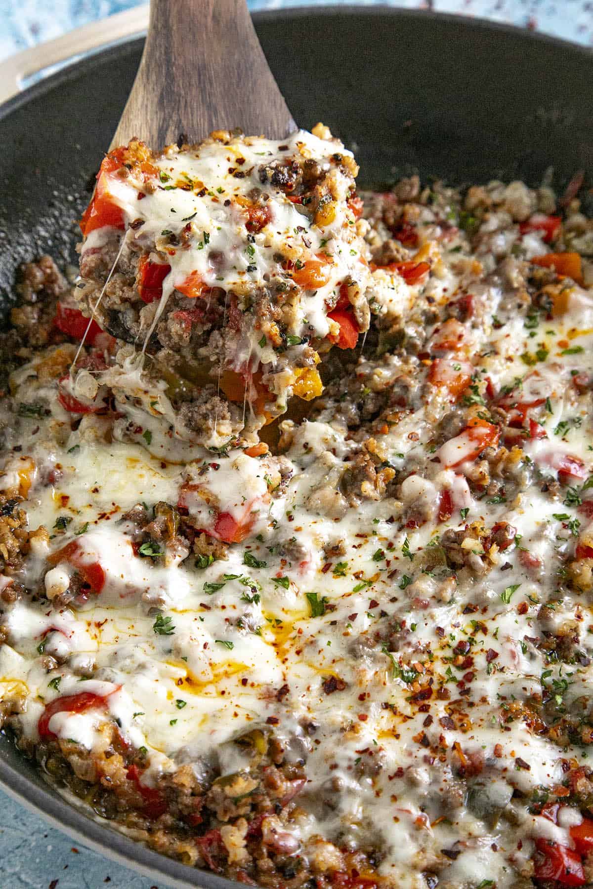 Mike scooping Stuffed Pepper Casserole from the pan