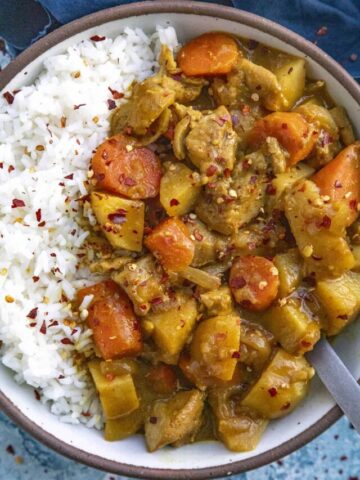 Japanese Curry in a bowl, garnished with chili flakes