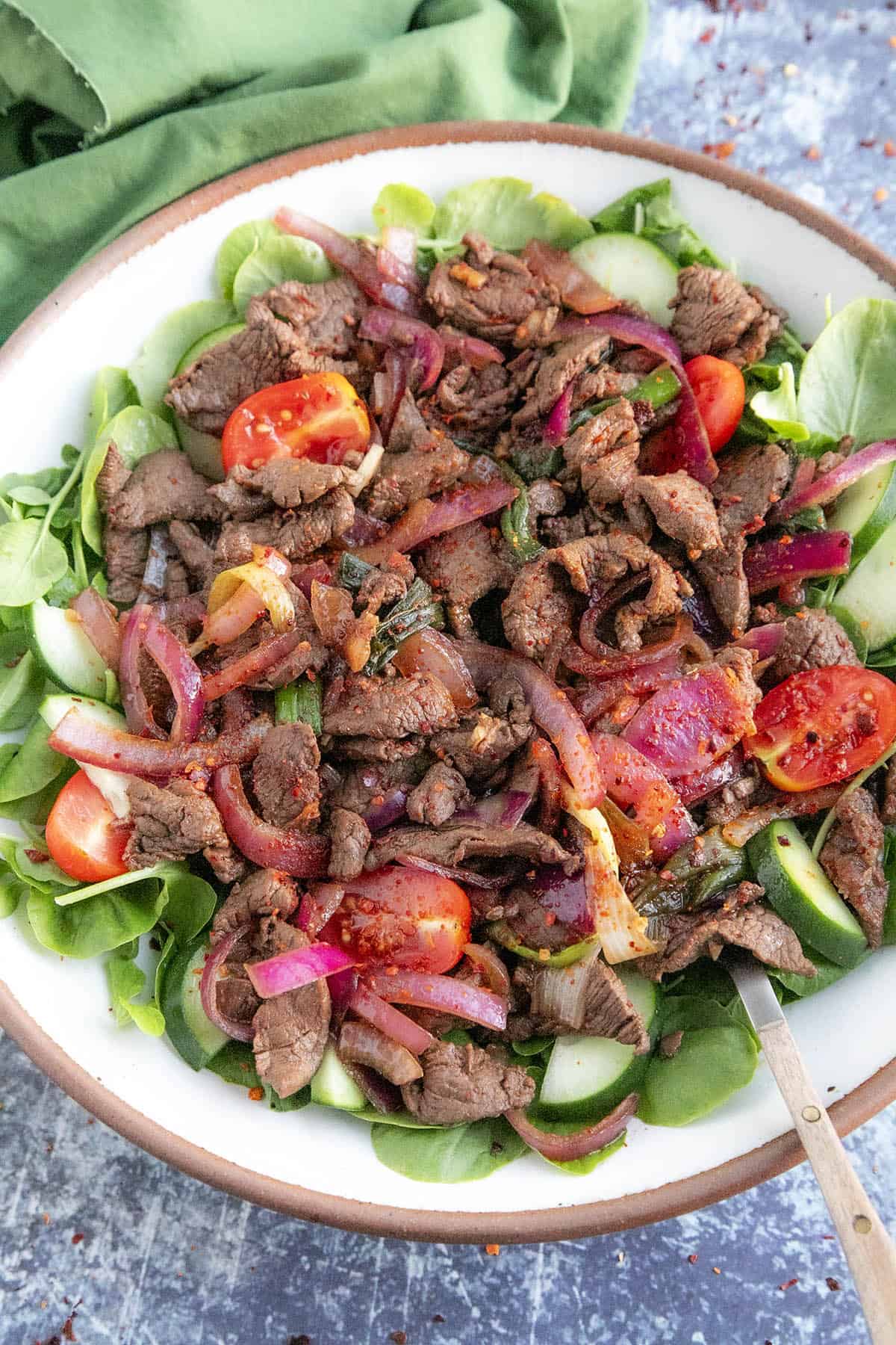 Vietnamese Shaking Beef (Bo Luc Lac) in a bowl with a fork