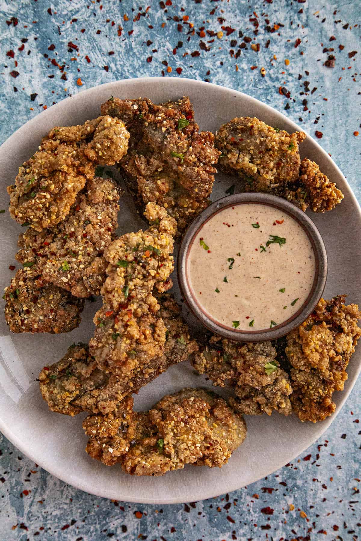 Fried oysters on a plate with creamy remoulade sauce