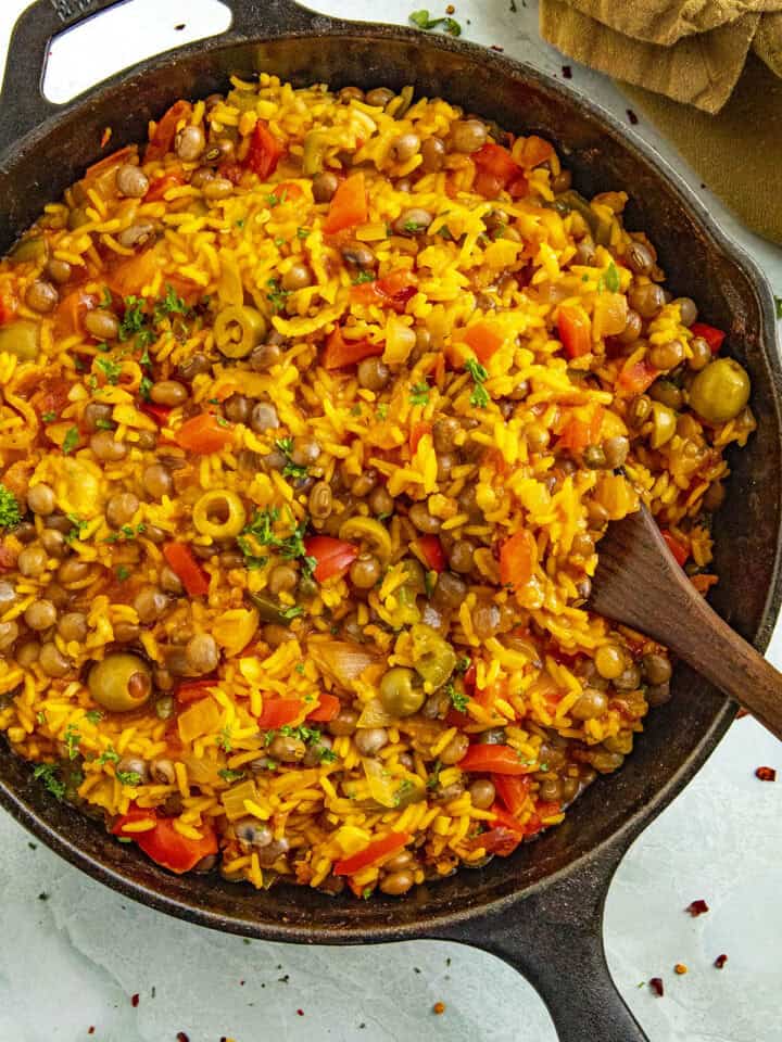 Scooping Arroz con Gandules from a pan