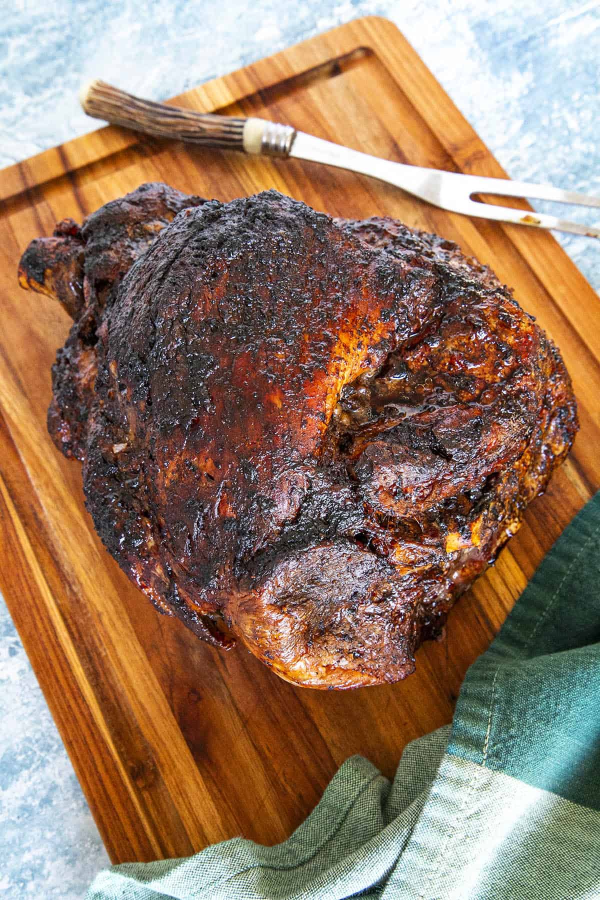 Cuban Roast Pork (Mojo Pork) on a cutting board, reading for carving