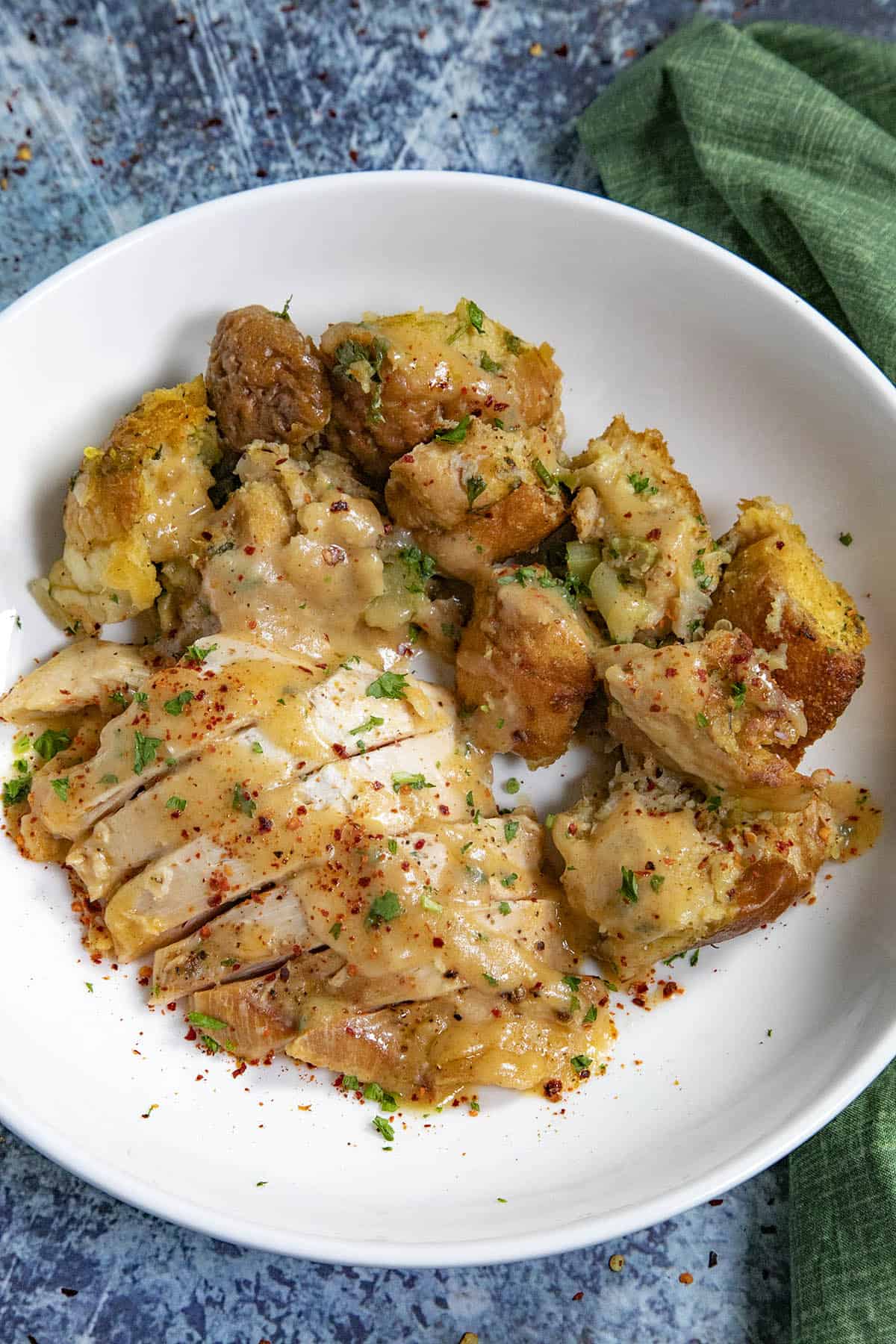 Oyster Dressing on a plate with sliced turkey breast and gravy