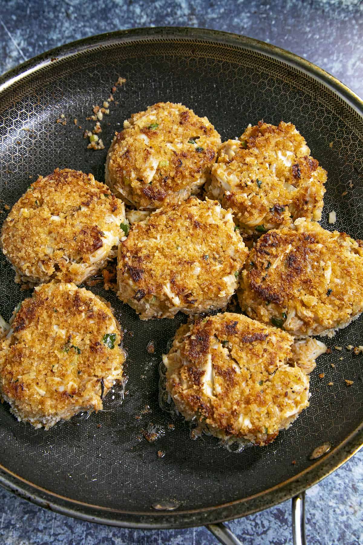 Cooking crab cakes in a hot pan