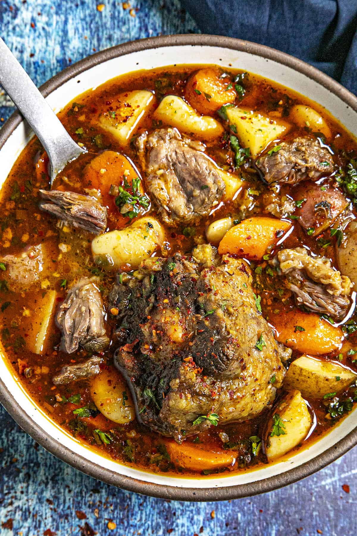 Serving hearty oxtail soup in a bowl