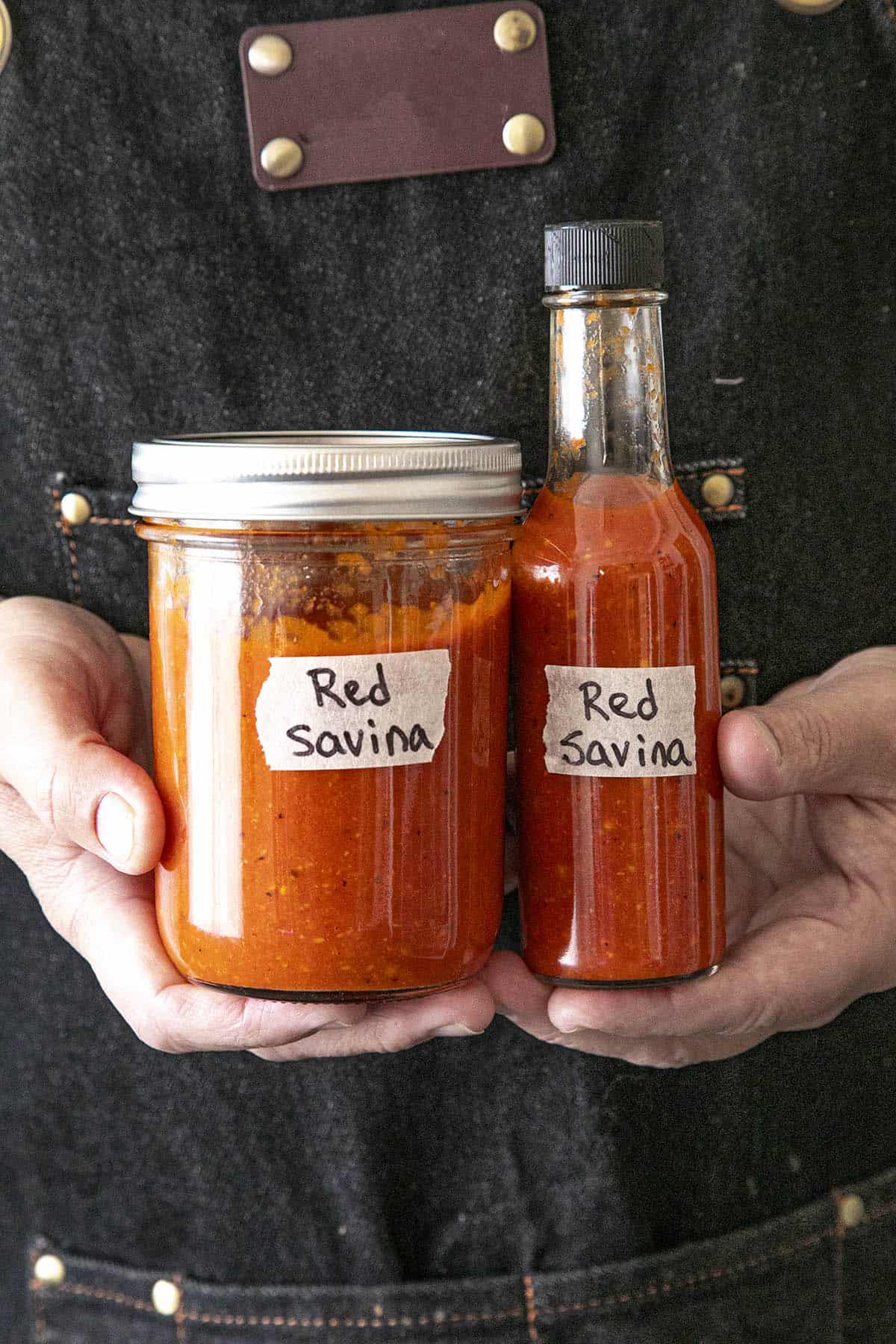 Mike holding a bottle and jar of Red Savina Habanero Hot Sauce