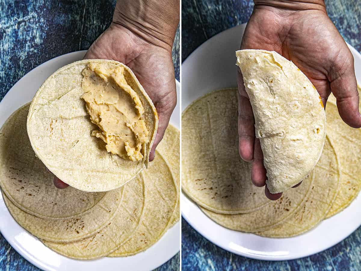 Mike hand forming a taco de papa (potato taco), filling it and folding the tortilla over the potato filling