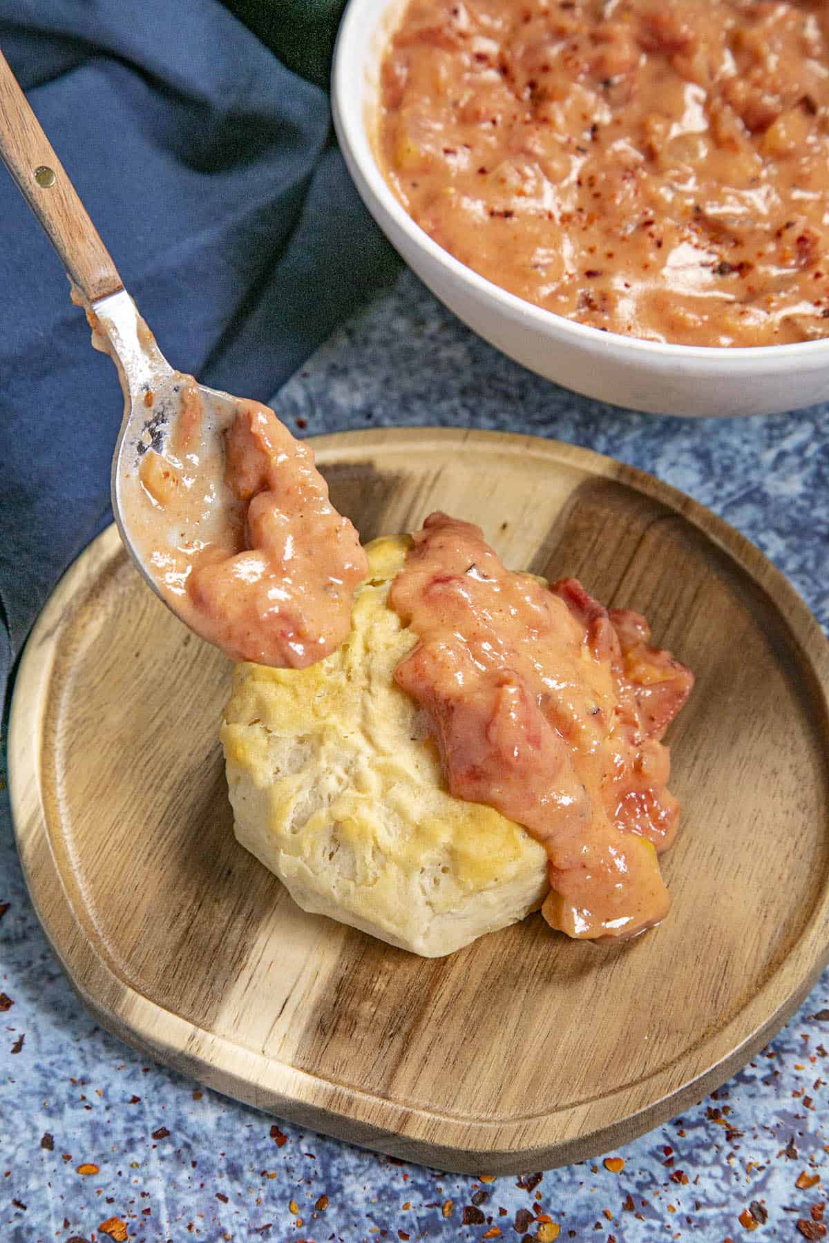 Smothering fresh made biscuits with rich tomato gravy