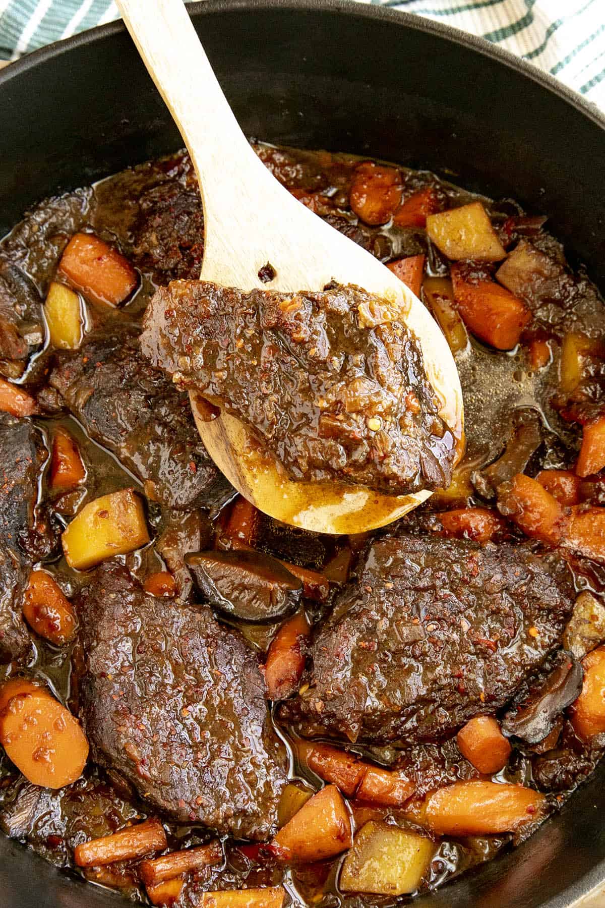 Serving a scoop of Galbi Jjim (Korean Braised Short Ribs) from the stew pot