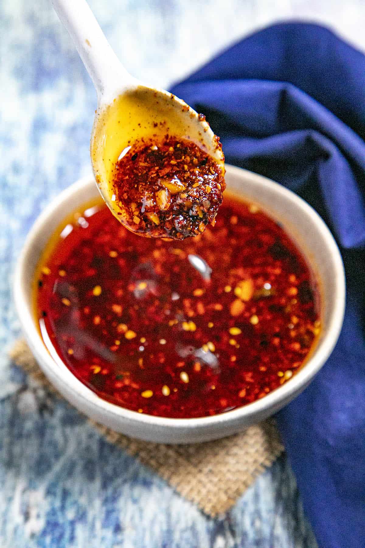 Rayu (Japanese Chili Oil) in a bowl, dripping from a spoon