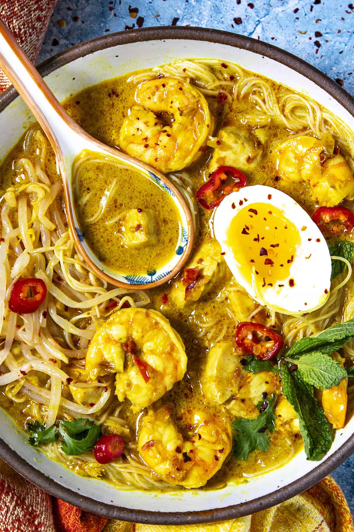 Homemade Coconut Curry Laksa in a bowl with a spoon