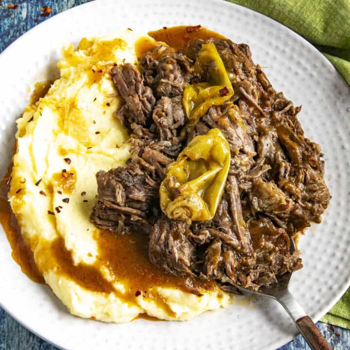 Mississippi Pot Roast on a serving plate with mashed potatoes