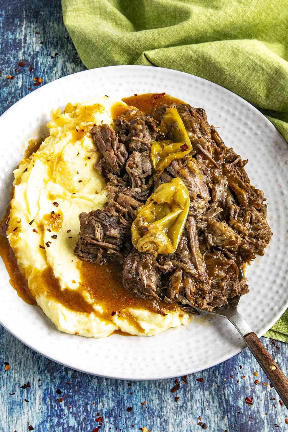 Mississippi Pot Roast on a serving plate with mashed potatoes