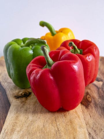 4 beautiful, colorful Bell Peppers on a platter