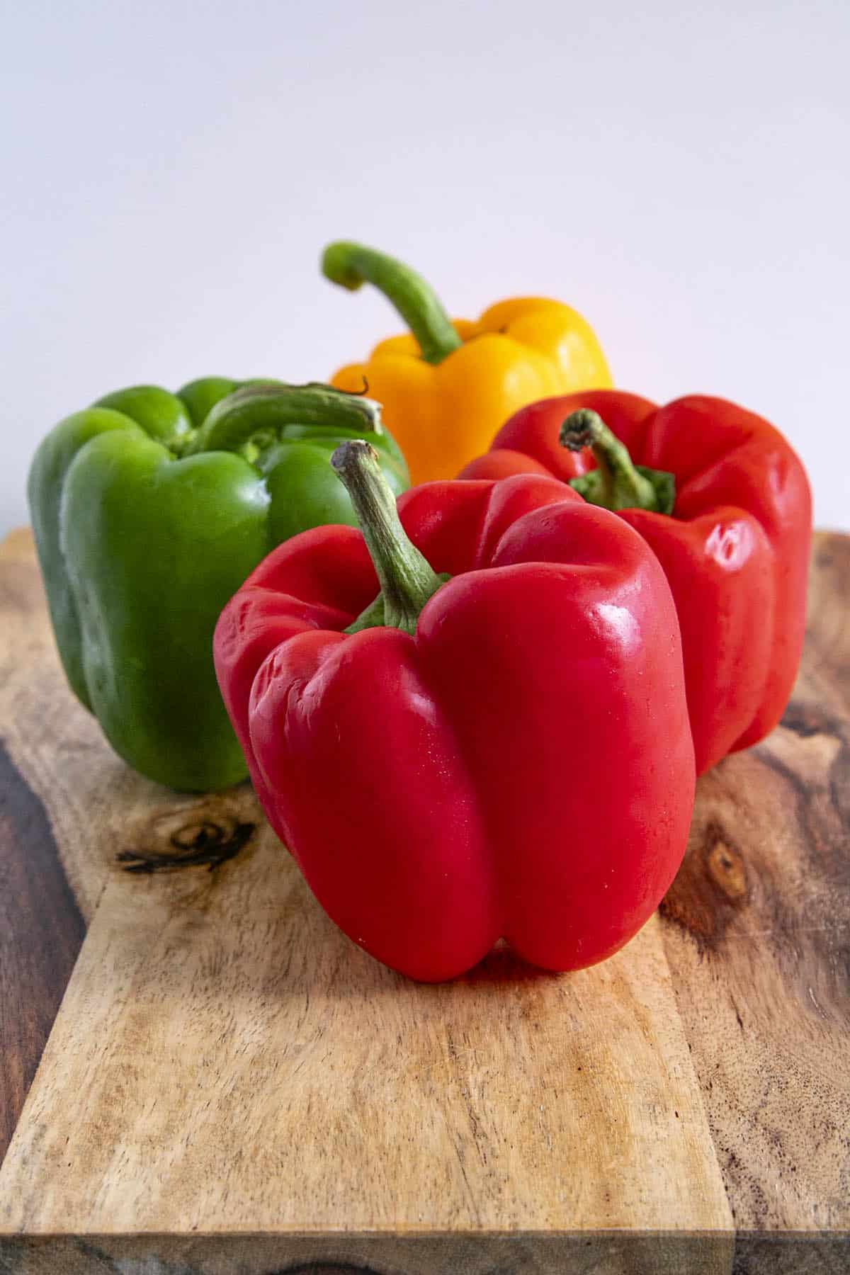 4 beautiful, colorful Bell Peppers on a platter