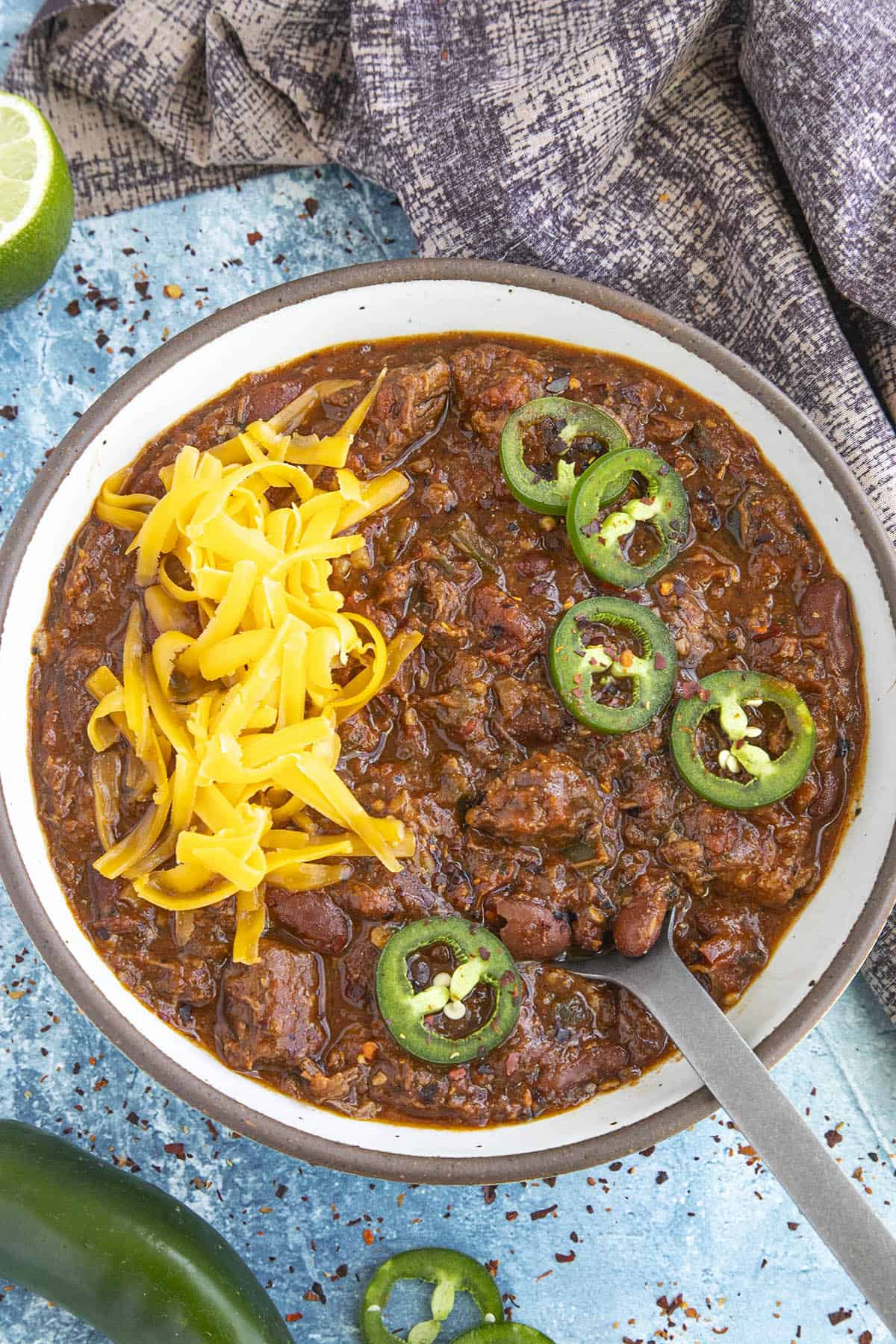 Brisket Chili in a bowl topped with cheese