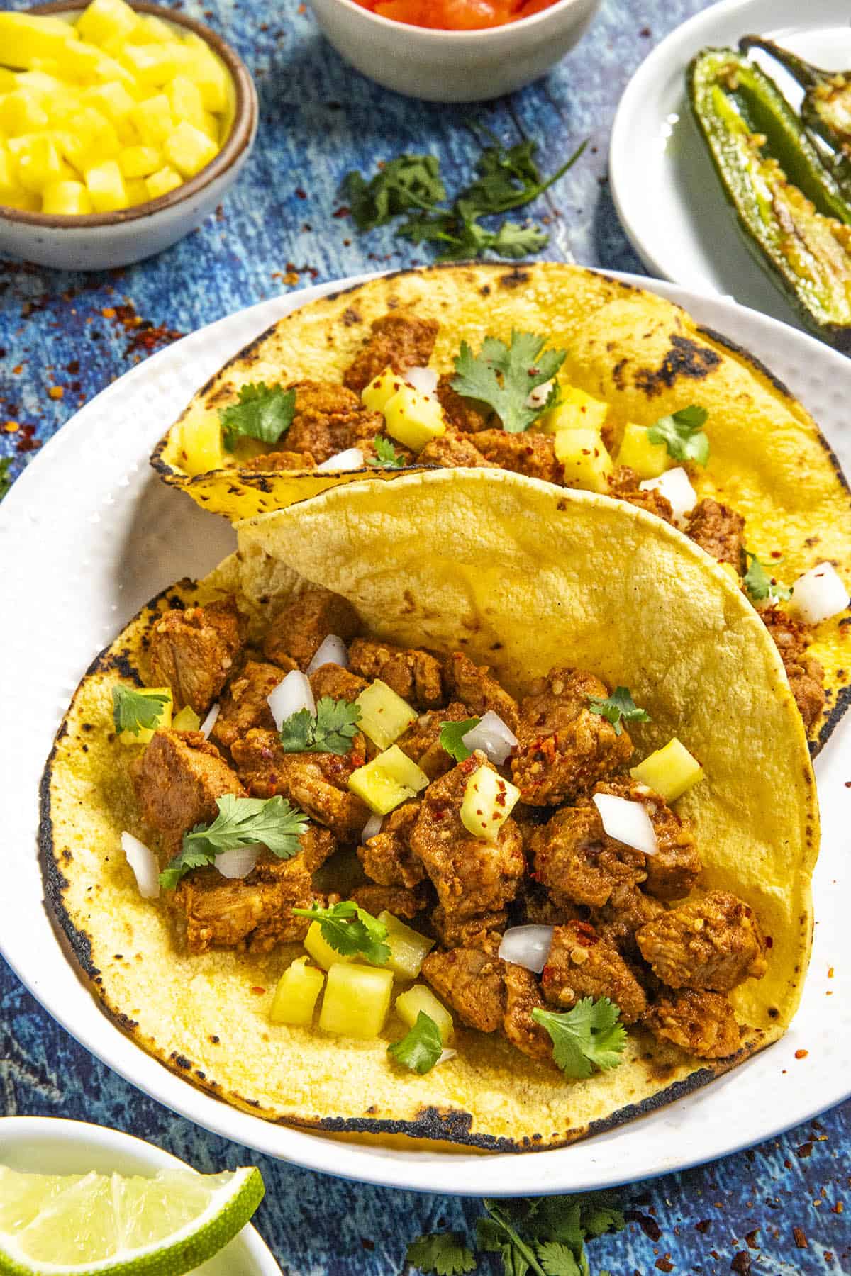 Tacos al Pastor served on toasted corn tortillas