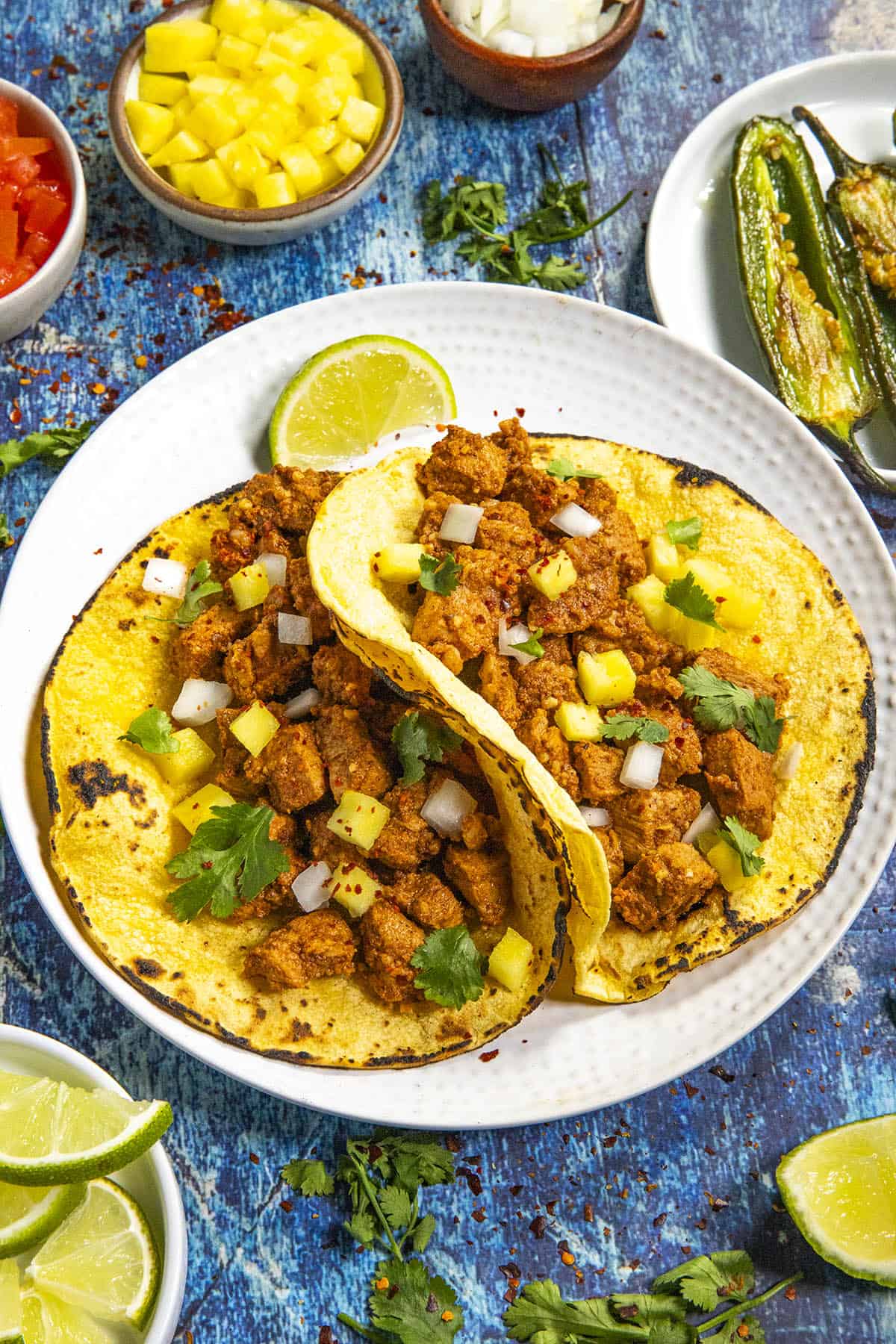 Tacos al Pastor on a plate with garnish