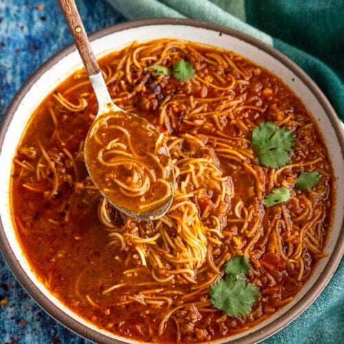 Spicy Mexican fideo soup in a bowl with a spoon, ready to serve