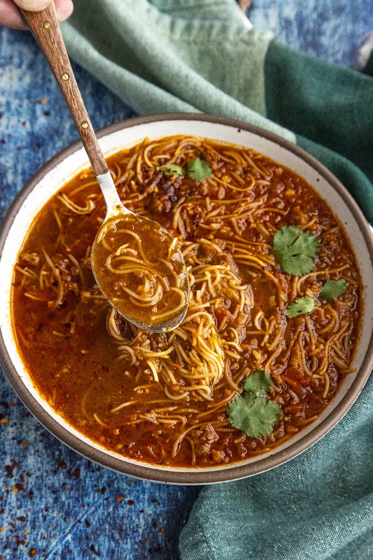 Spicy Mexican fideo soup in a bowl with a spoon, ready to serve