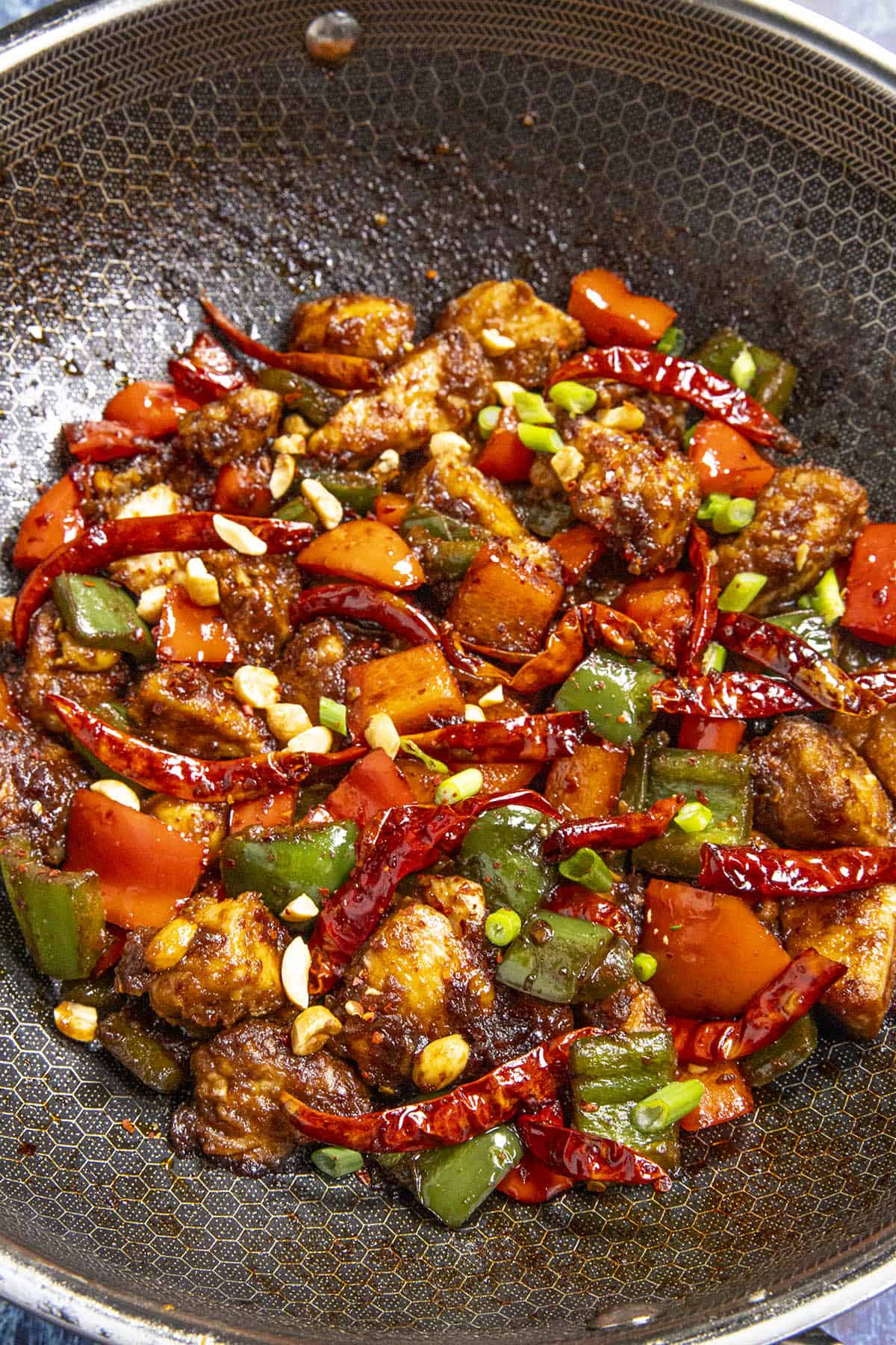 Spicy Szechuan Chicken in a hot wok, ready to serve