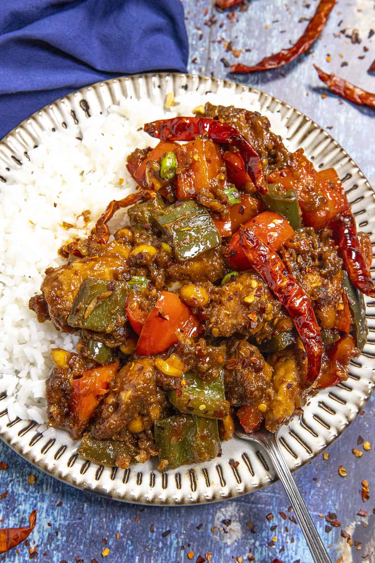 Spicy Szechuan Chicken served on a plate with rice