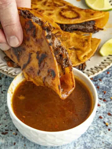 Mike dipping a Birria taco into consome