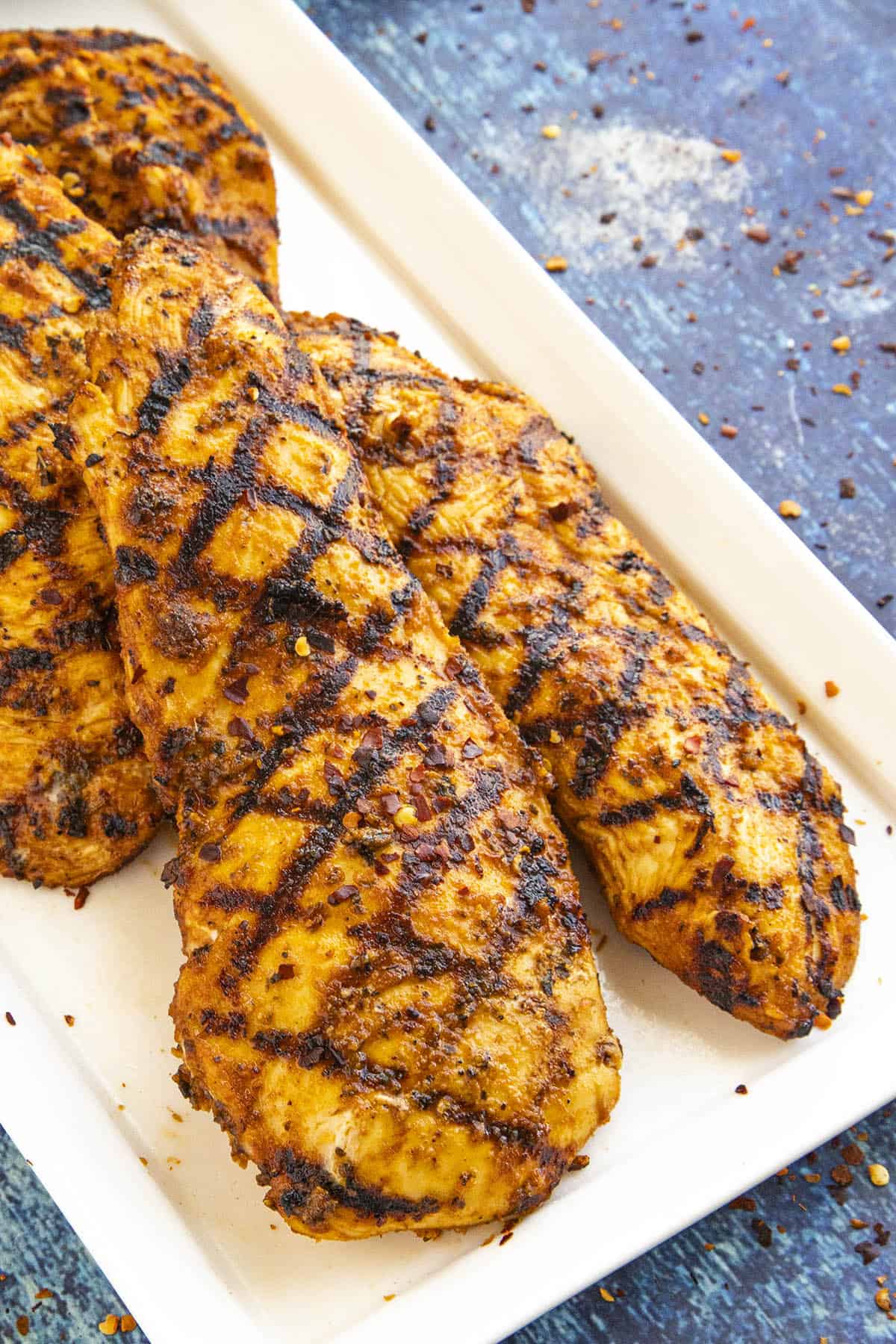 Perfectly grilled chicken on a plate, so juicy and moist from the chicken marinade