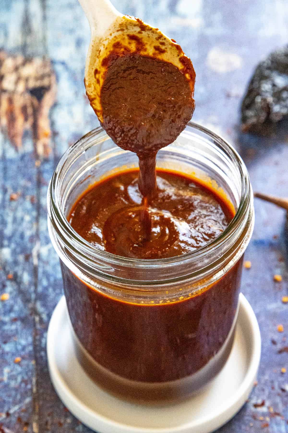 Homemade Enchilada Sauce dripping from a spoon