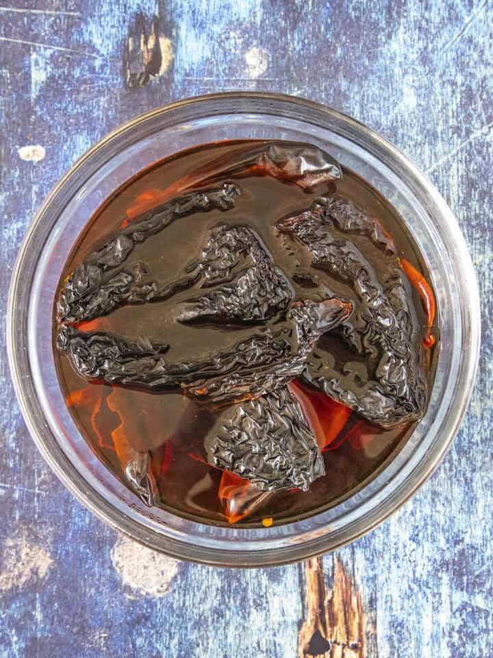 Soaking dried chilies to make Red Enchilada Sauce