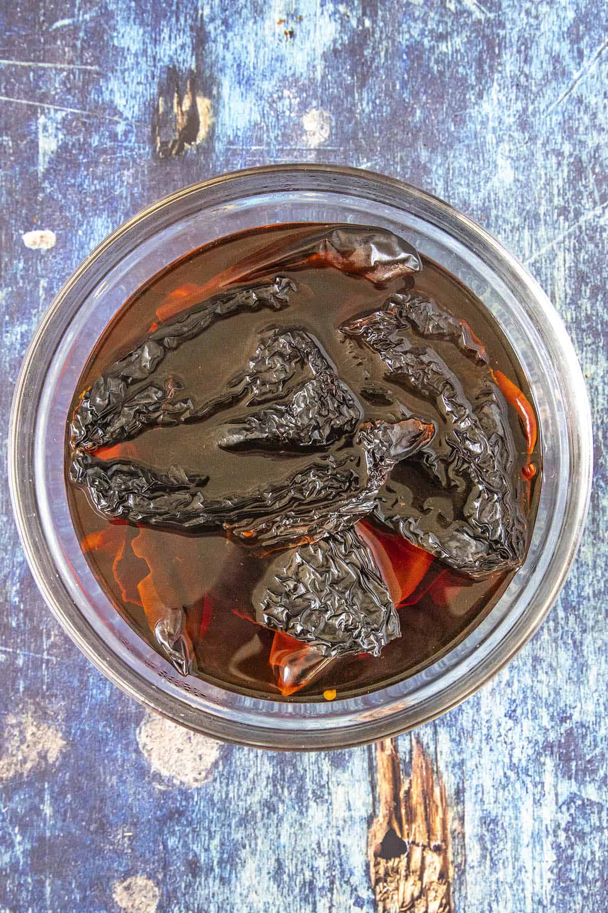 Soaking dried chilies to make Red Enchilada Sauce