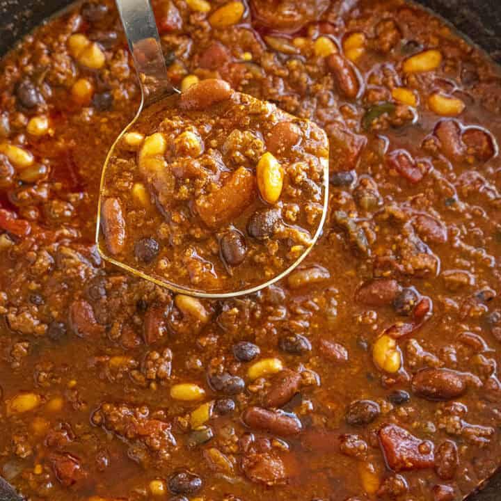Mike serving a ladle full of Three Bean Chili from the pot