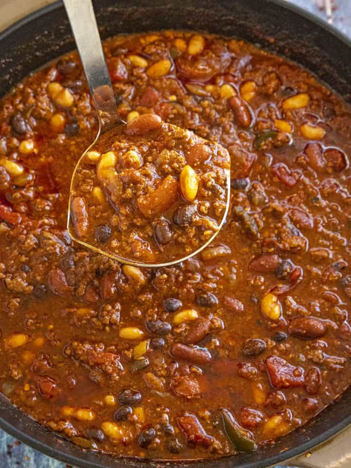 Mike serving a ladle full of Three Bean Chili from the pot