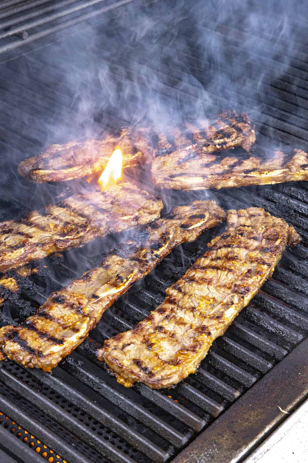 Grilling Korean BBQ Beef Short Ribs (Galbi or Kalbi) on a hot grill
